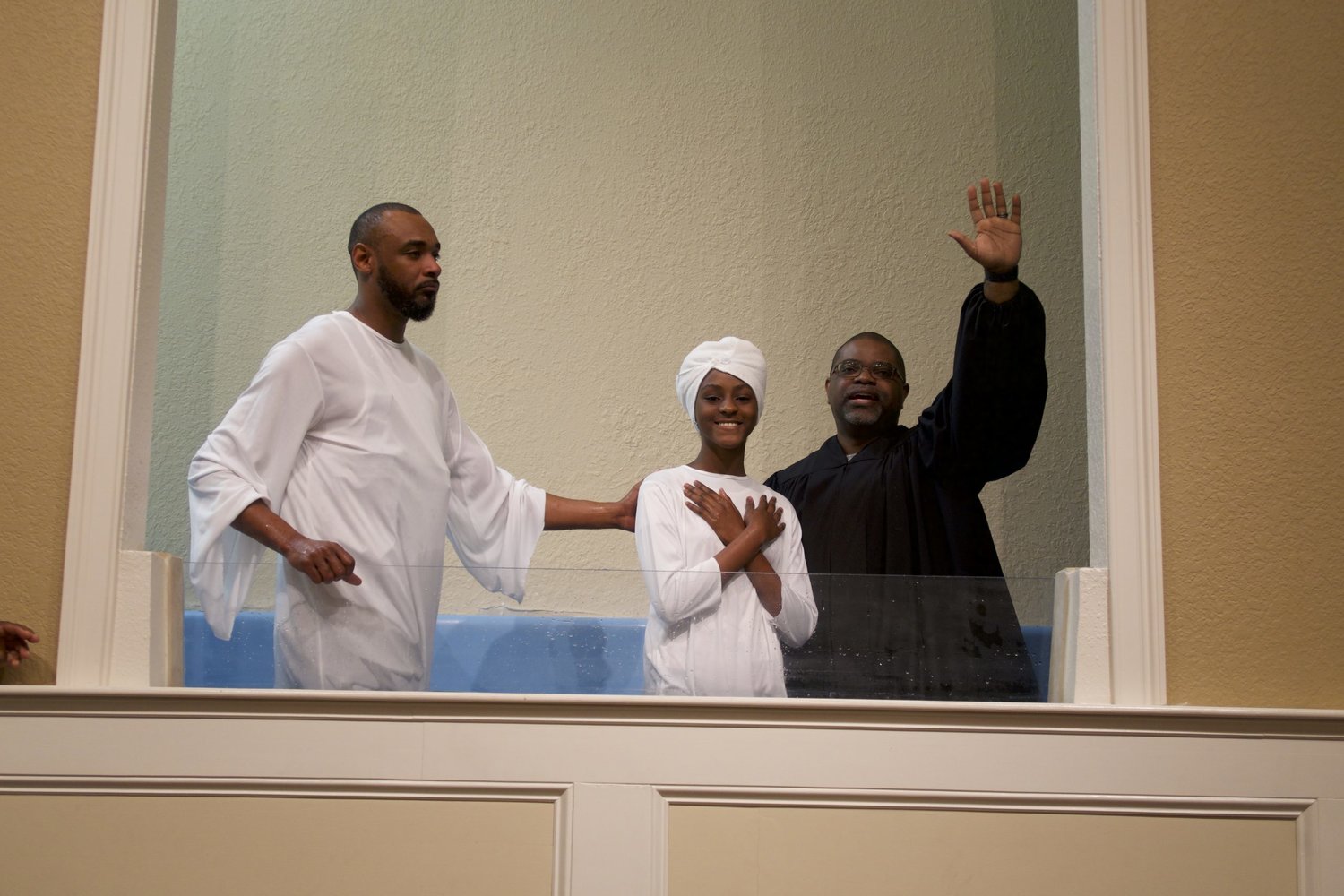 Pastor Adrian Taylor, right, of Springhill Missionary Baptist Church in Gainesville, Fla., rejoices after a baptism at the church. Taylor credits God and His unchanging Word for the church's growth.