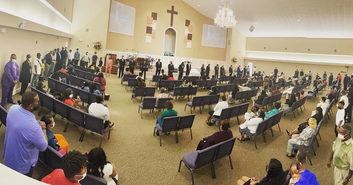 Worshippers at Springhill Missionary Baptist Church in Gainesville, Fla., gather in a prayer circle at the church.