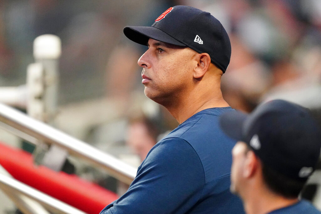 A clean-shaven Boston Red Sox manager Alex Cora looks on from the dugout during a game against the Atlanta Braves, Tuesday, May 10, 2022, in Atlanta. The Red Sox beat the Braves 9-4 after Cora decided to shave his salt-and-pepper beard before the series. He grew out his facial hair ahead of the season and joked that it was to blame for his team’s poor start. (AP Photo/John Bazemore)