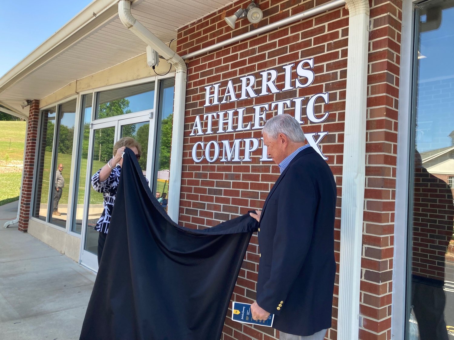 By removing a drape, Gerald Harris and his wife, Martha Jean, get the first look at the name of the Harris Athletic Complex. (Index/Roger Alford)