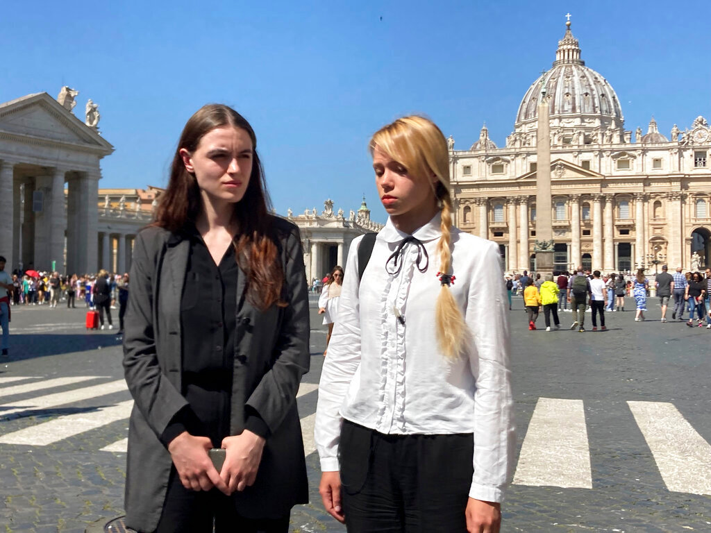 Kateryna Prokopenko, right, wife of Azov Regiment Commander Denys Prokopenko, and Yuliia Fedosiuk, both from Ukraine, talk with The Associated Press at the end of the weekly general audience where they met with Pope Francis, in St. Peter's Square at the Vatican, Wednesday, May 11, 2022. (AP Photo/Nicole Winfield)