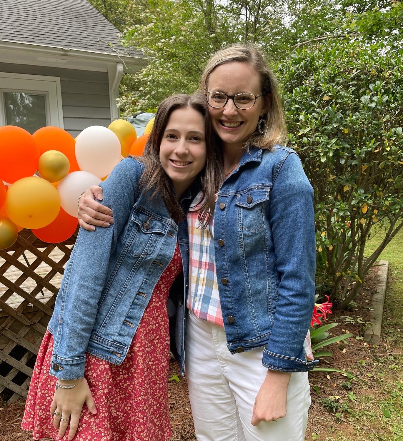 Abby Trent, left, and Krysta Jordan embrace at a graduation party. (Photo/Chris Trent, GBMB)