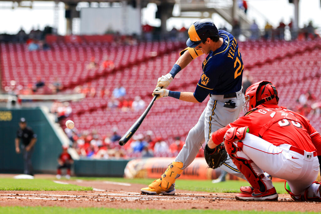 Milwaukee Brewers' Christian Yelich hits a ground-rule double during the first inning against the Cincinnati Reds in Cincinnati, Wednesday, May 11, 2022. (AP Photo/Aaron Doster)
