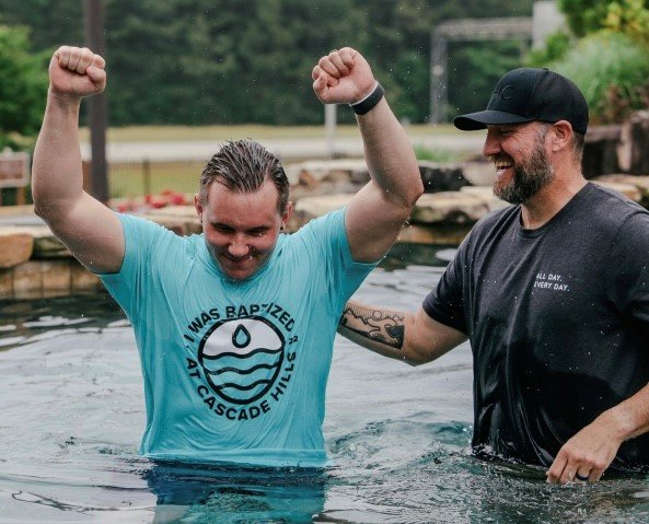A new believer celebrates his baptism at Cascade Hills Baptist Church in Columbus, Ga.