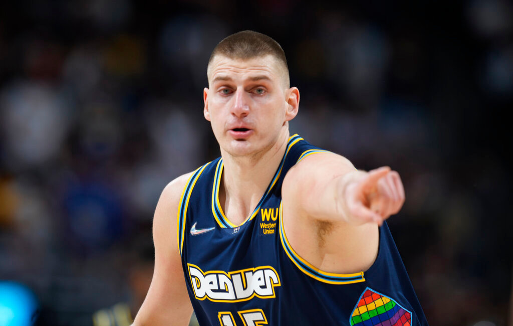 Denver Nuggets center Nikola Jokic gestures after hitting a 3-point-basket against the Golden State Warriors in an NBA playoff game April 24, 2022. (AP Photo/David Zalubowski, File)