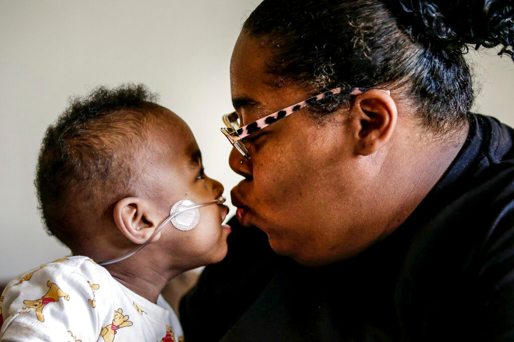 Curtis Means kisses his mother, Michelle Butler at their home in Eutaw, Ala., on Wednesday, March 23, 2022. (AP Photo/Butch Dill)