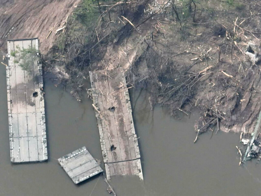 A photo provided by the Ukraine Armed Forces on Thursday, May 12, 2022, a ruined pontoon crossing with dozens of destroyed or damaged Russian armored vehicles on both banks of Siverskyi Donets River in eastern Ukraine. Ukrainian and British officials say Russia suffered heavy losses when Ukrainian forces destroyed the pontoon bridge enemy troops were using to try to cross the river. (Ukrainian Presidential Press Office via AP)