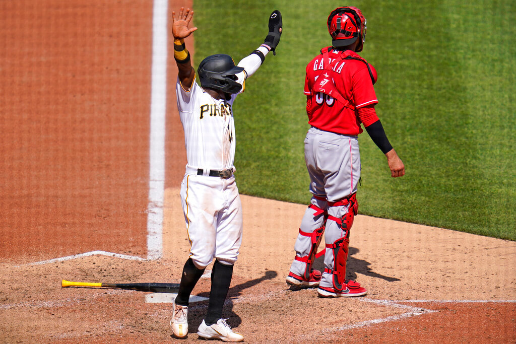 Pittsburgh Pirates' Rodolfo Castro celebrates as teammate Ke'Bryan Hayes (not shown) beats out a fielder's choice, allowing Castro to score from third, during the eighth inning against the Cincinnati Reds in Pittsburgh, Sunday, May 15, 2022. (AP Photo/Gene J. Puskar)