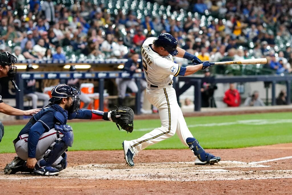 Milwaukee Brewers' Hunter Renfroe hits a double during the sixth inning against the Atlanta Braves, Monday, May 16, 2022, in Milwaukee. (AP Photo/Morry Gash)