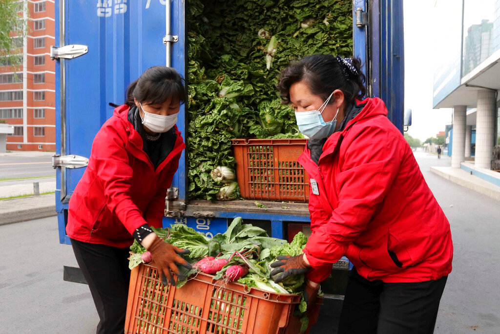 Employees of a greengrocery deliver food to residents staying home as the state increased measures to stop the spread of illness in Pyongyang, North Korea Monday, May 16, 2022. (AP Photo/Jon Chol Jin)