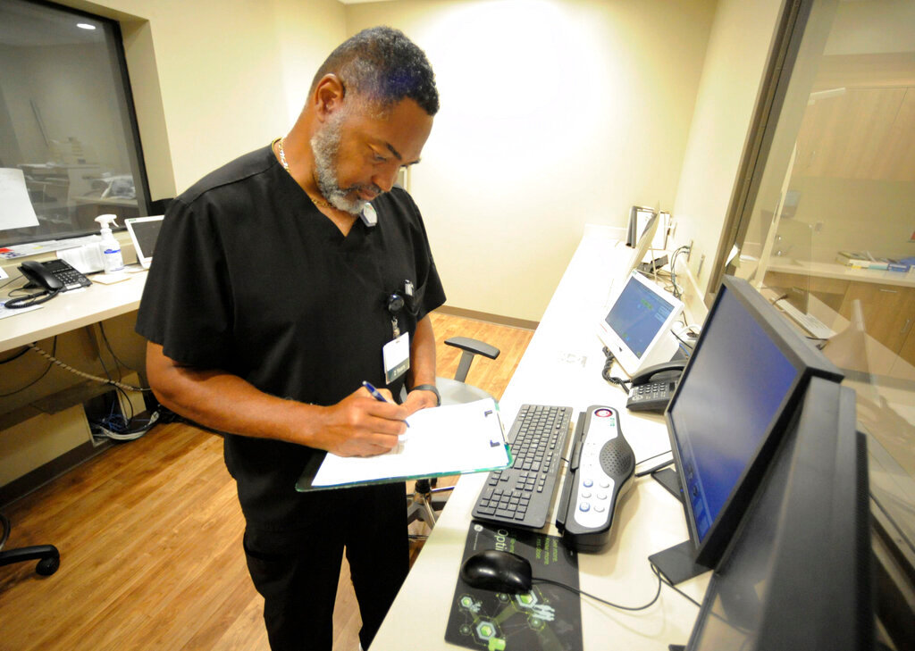 Radiology manager Marshall C. Pritchett Jr. works on a file at Thomasville Regional Medical Center in Thomasville, Ala., May 3, 2022. The hospital is among three in the nation that say they are missing out on federal pandemic relief money because they opened during or shortly before the COVID-19 crisis began. (AP Photo/Jay Reeves)