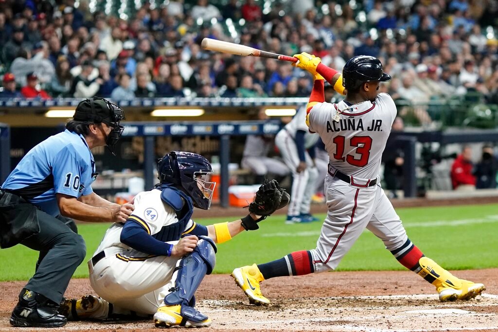 Atlanta Braves' Ronald Acuña Jr. hits the ball towards third base during the fifth inning against the Milwaukee Brewers, Tuesday, May 17, 2022, in Milwaukee. The ball that went off the glove of Brewers third baseman Mike Brosseau and headed into left field, allowing Adam Duvall to score an unearned run. (AP Photo/Morry Gash)