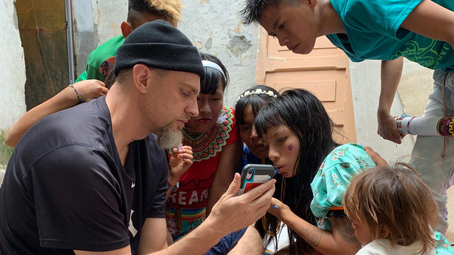 IMB missionary Travis Burkhalter visits with friends from an indigenous people group he serves among in Medellin, Colombia.