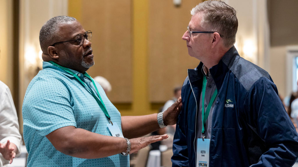 IMB trustees Ricky Wilson. left. and Keith Evans talk after the meeting May 19 in Orlando, Fla. (IMB Photo)