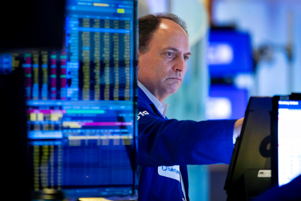 Trader James Conti works on the floor on the New York Stock Exchange, Friday, May 20, 2022. The stock market clawed back from a midday drop Friday after coming to the edge of its first bear market since the beginning of the pandemic. (Allie Joseph/New York Stock Exchange via AP)