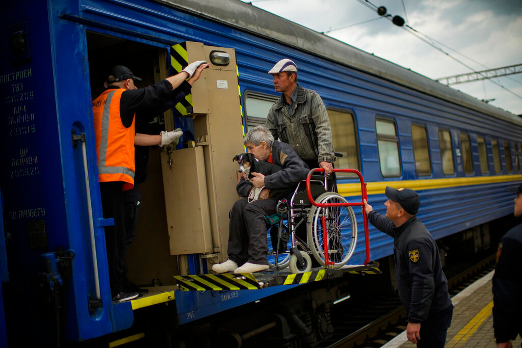 People fleeing from shelling board an evacuation train at the  train station in Pokrovsk, eastern Ukraine, Sunday, May 22, 2022. (AP Photo/Francisco Seco)