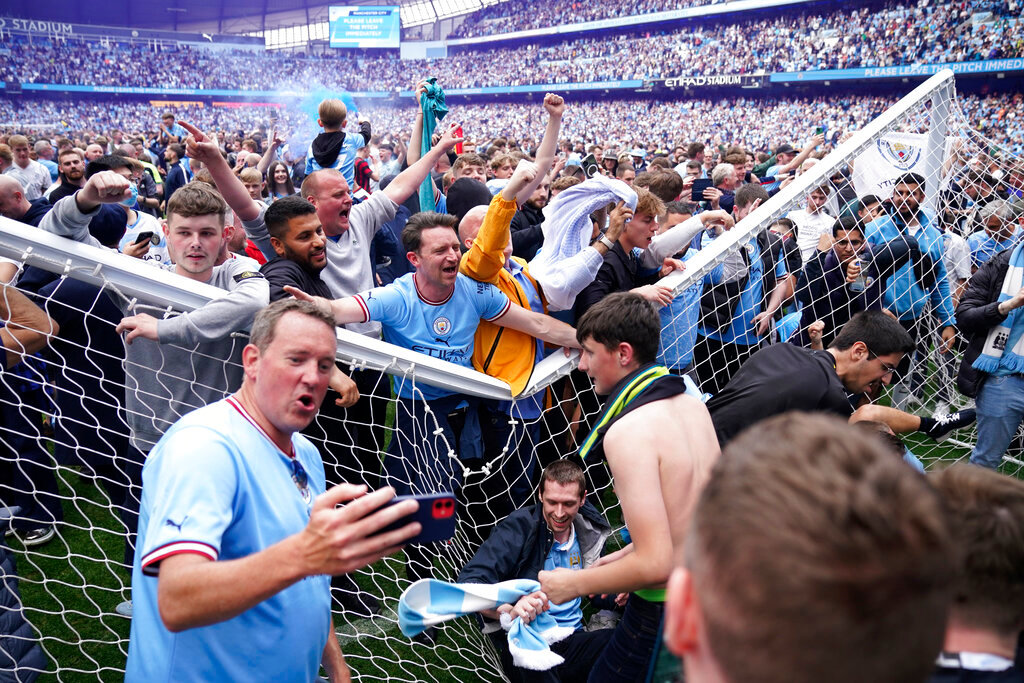 Manchester City fans celebrate after the English Premier League soccer match between Manchester City and Aston Villa in Manchester, England, Sunday, May 22, 2022. Manchester City won the match against Aston Villa and secured the 2022 Premier League title. (AP Photo/Dave Thompson)