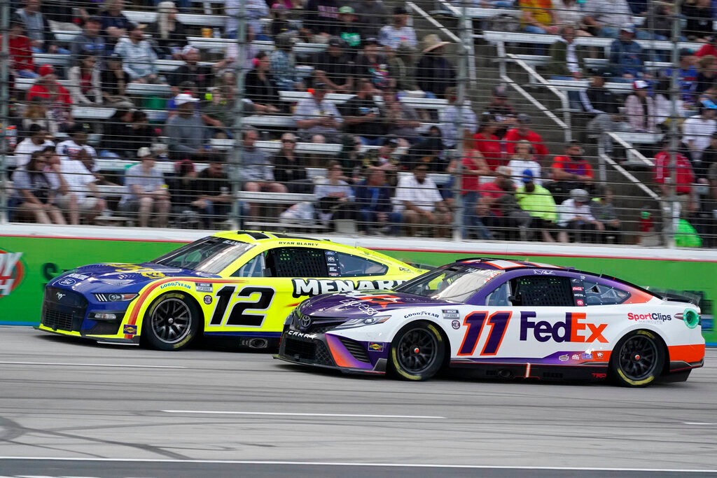 Denny Hamlin (11) and Ryan Blaney (12) drive during the NASCAR All-Star auto race at Texas Motor Speedway in Fort Worth, Texas, Sunday, May 22, 2022. (AP Photo/Larry Papke)