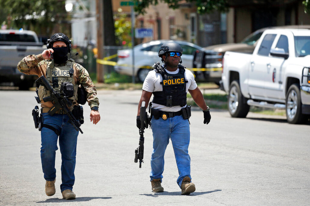 Police walk near the Robb Elementary school in Uvalde, Texas Tuesday, May 24, 2022. (AP Photo/Dario Lopez-Mills)..