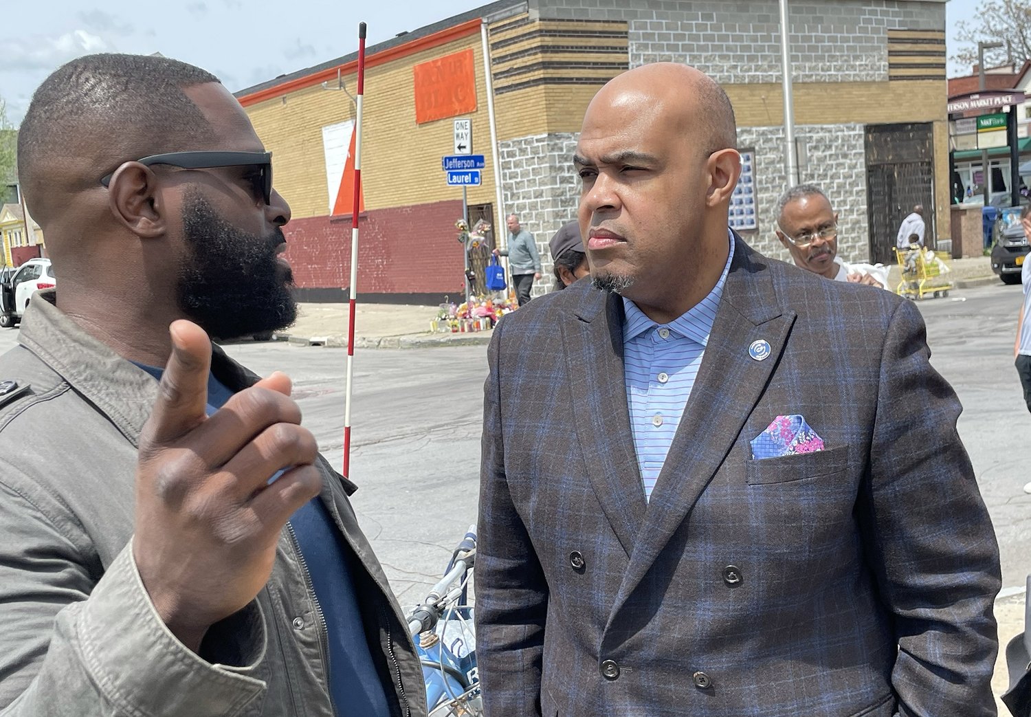 Willie McLaurin, right, speaks with Mark Hamilton, senior pastor of Faithful Stones Church, a non-Southern Baptist evangelical church, near the scene of the mass shooting at a Buffalo, N.Y., supermarket.