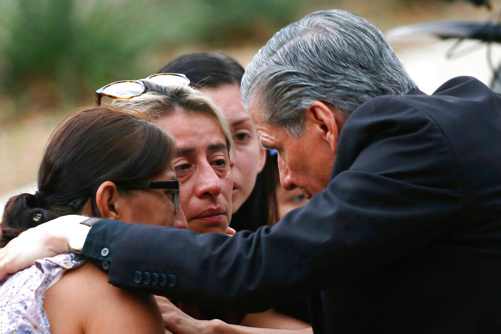 The Archbishop of San Antonio, Gustavo Garcia Seller, comforts families outside of the Civic Center following a deadly school shooting at Robb Elementary School in Uvalde, Texas Tuesday, May 24, 2022. (AP Photo/Dario Lopez-Mills)