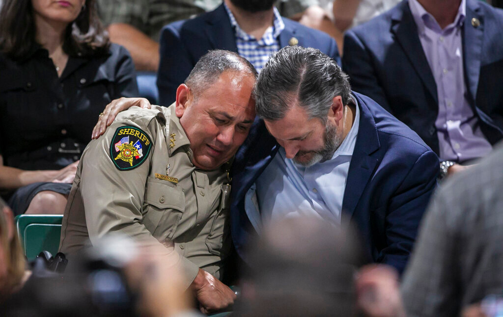 Uvalde County Sheriff Ruben Nolasco, left, is comforted by U.S. Sen. Ted Cruz during a vigil held in honor of the lives lost at Robb Elementary school at the Uvalde County Fairplex Arena in Uvalde, Texas, Wednesday, May 25, 2022. (Josie Norris/The San Antonio Express-News via AP)