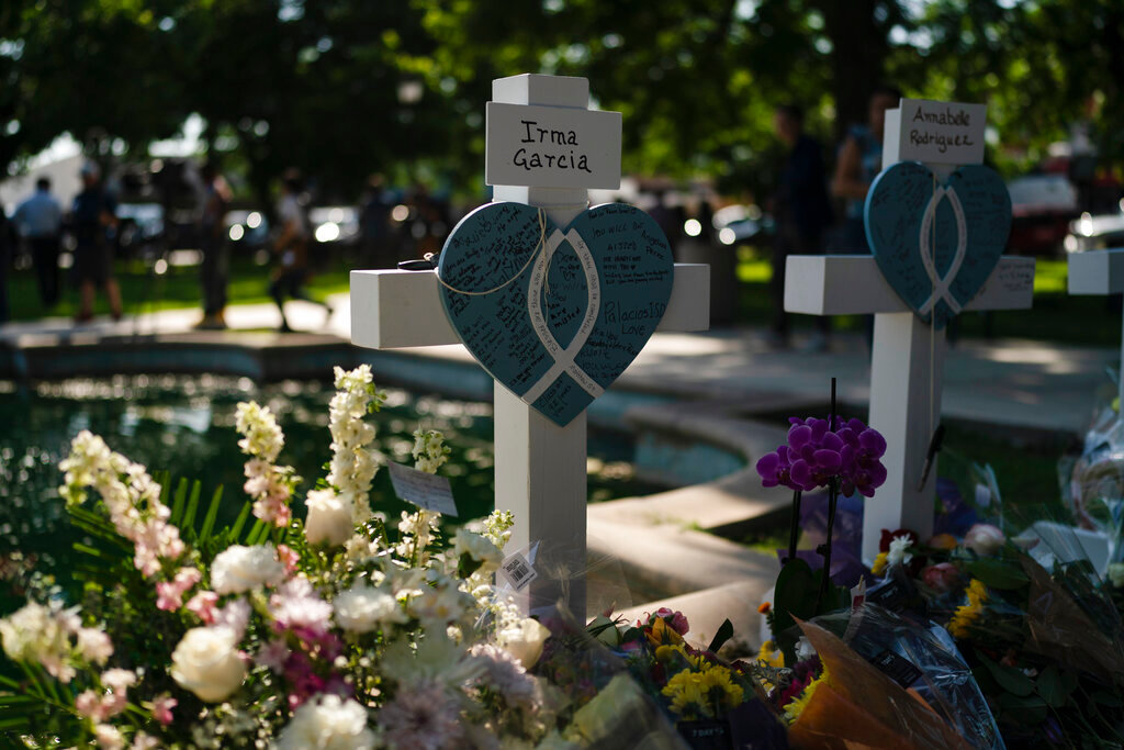 Messages are written on a cross honoring Irma Garcia, a teacher who was killed in this week's elementary school shooting, in Uvalde, Texas, Thursday, May 26, 2022. (AP Photo/Jae C. Hong)