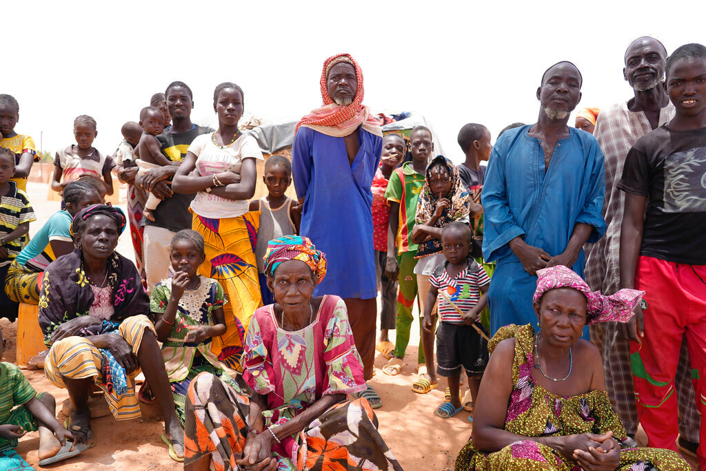 People wait for aid in Djibo, Burkina Faso, on Thursday May 26, 2022. (AP Photo/Sam Mednick)