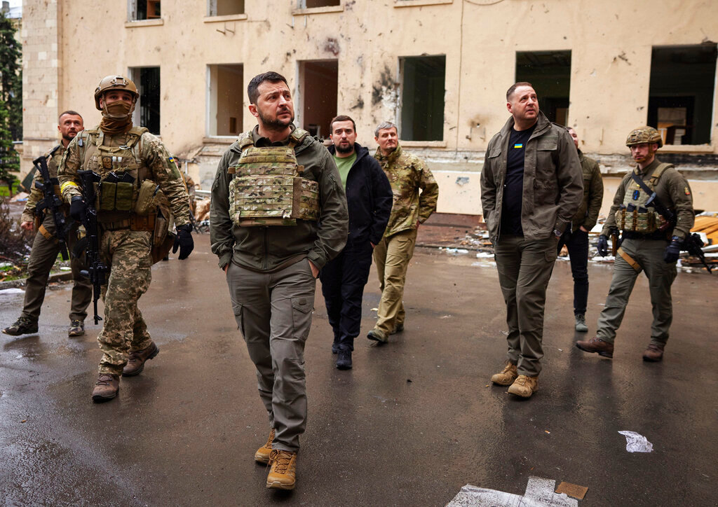 Ukrainian President Volodymyr Zelenskyy walks with his staff as he visits the war-hit Kharkiv region. (Ukrainian Presidential Press Office via AP)