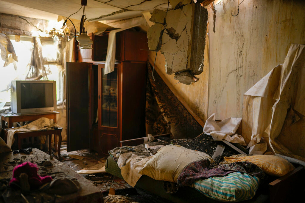 Debris covers the living room of an apartment in a residential building heavily damaged in a Russian bombing in Bakhmut, eastern Ukraine, Monday, May 30, 2022. (AP Photo/Francisco Seco)