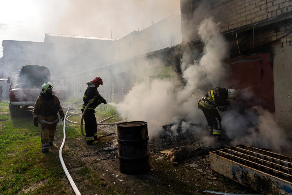 Ukrainian firefighters try to extinguish a fire in a warehouse after a Russian strike in Kharkiv, eastern Ukraine, Monday, May 30, 2022. (AP Photo/Bernat Armangue)