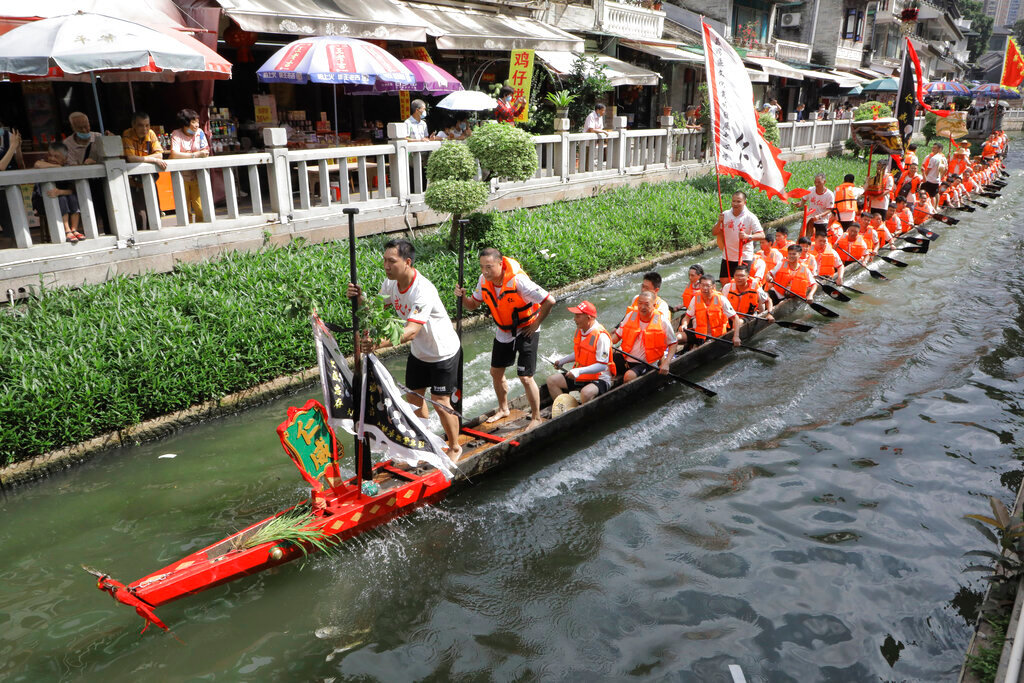 Participants from Panting village row along a canal in the historic Lychee Bay scenic area in Guangzhou in southern China's Guangdong Province, Friday, June 3, 2022. (AP Photo/Caroline Chen)