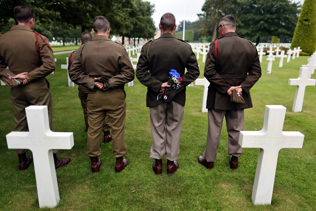 World War II history enthusiasts pay respect in the US cemetery of Colleville-sur-Mer, Normandy, Saturday, June, 4 2022. (AP Photo/Jeremias Gonzales)
