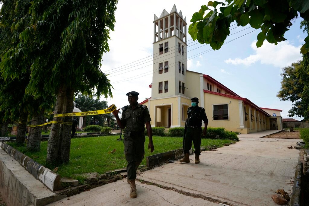 Nigerian police officers place tape around St. Francis Catholic church in Owo Nigeria, Monday, June 6, 2022. (AP Photo/Sunday Alamba)