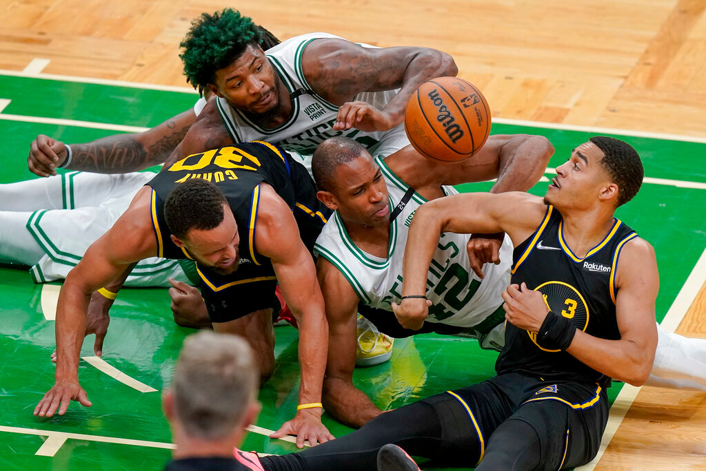 Boston Celtics center Al Horford (42) and guard Marcus Smart, top, battle for a loose ball against Golden State Warriors guard Jordan Poole (3) and guard Stephen Curry (30) during the fourth quarter of Game 3 of the NBA Finals, Wednesday, June 8, 2022, in Boston. (AP Photo/Steven Senne)