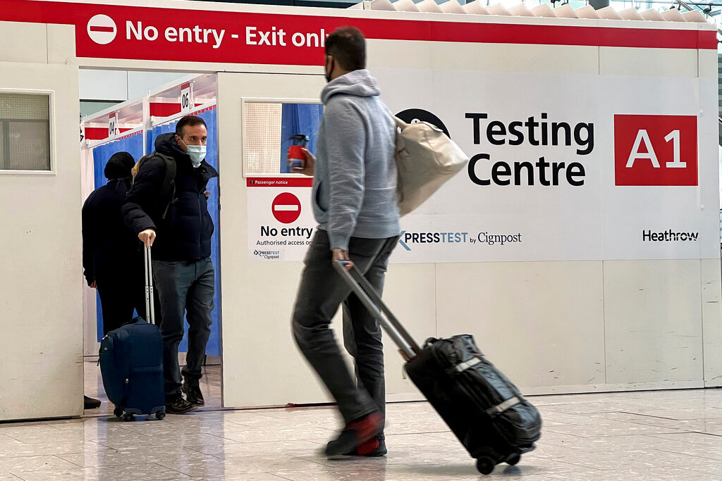 Passengers get a COVID-19 test at Heathrow Airport in London, Nov. 29, 2021. (AP Photo/Frank Augstein, File)