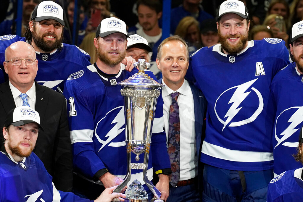 Tampa Bay Lightning center Steven Stamkos, head coach Jon Cooper, and defenseman Victor Hedman pose with the Prince of Wales Trophy after the team defeated the New York Rangers in the Stanley Cup playoffs Eastern Conference finals Saturday, June 11, 2022, in Tampa, Fla. (AP Photo/Chris O'Meara)