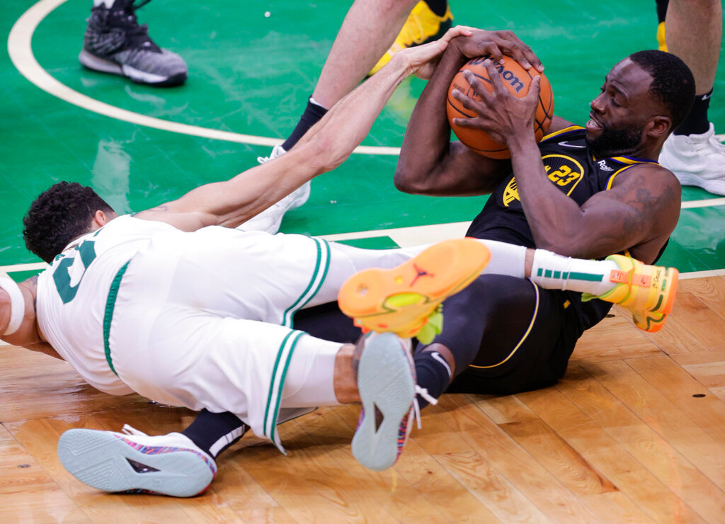 Golden State Warriors' Draymond Green (23) fights for the ball with Boston Celtics' Jayson Tatum during the fourth quarter of Game 4 of the NBA Finals in Boston, Mass., Friday, June 10, 2022. (Carlos Avila Gonzalez/San Francisco Chronicle via AP)