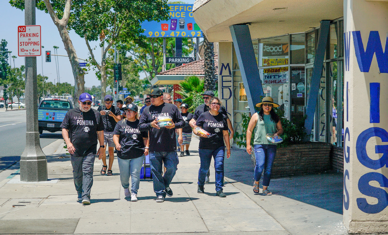 Southern Baptist Convention President Ed Litton, far left, and Hector Medina, middle, pastor of Salvo Por Gratia in Pomona, Calif., walk the streets of Pomona with members of the church to pass out snacks June 11, 2022, during a Crossover Anaheim event. (NAMB/Adam Covington)