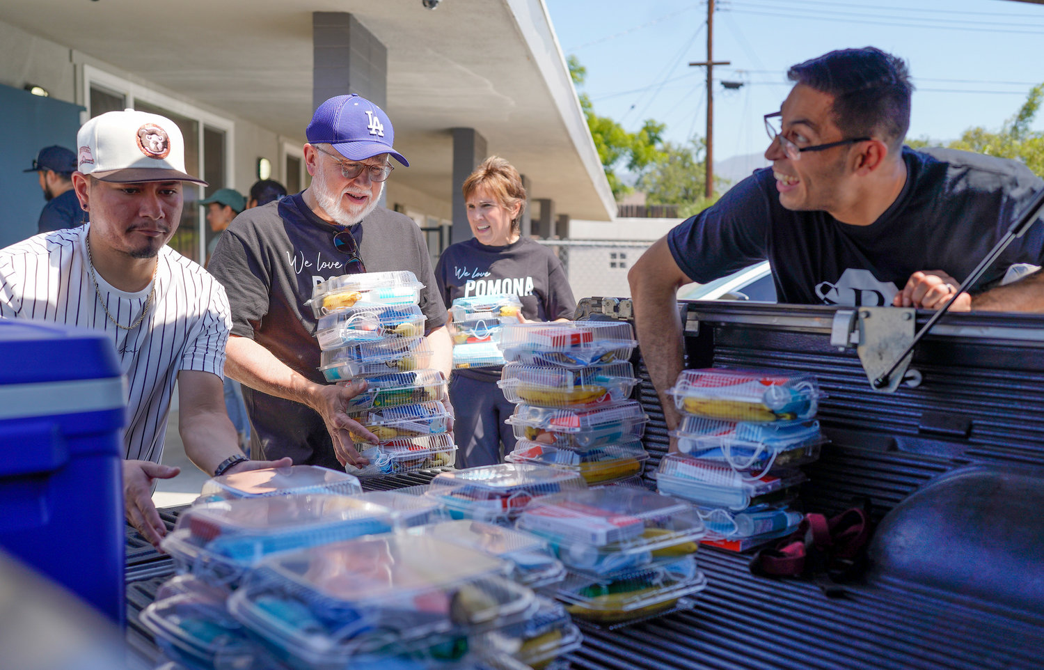 Southern Baptist Convention President Ed Litton, center, and his wife, Kathy, stack boxes of food with Leo Sanchez, left, and Jorge Valencia, right, at Salvo Por Gratia in Pomona, Calif., June 11, 2022. The food was distributed to homeless in the community as part of Crossover Anaheim. (NAMB/Adam Covington)