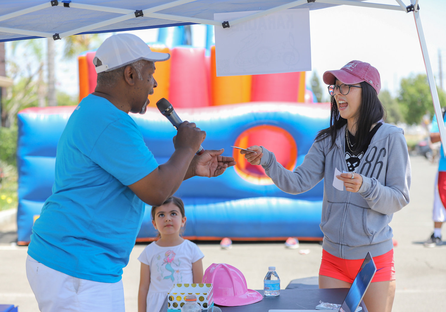 Reverend Felton Patrick Christian, interim director of outreach and evangelism at Friendship Baptist Church in Yorba Linda, Calif., awards a raffle prize to attendee Anne Yip at a block party at the church June 11 as part of Crossover Anaheim. The block party included free food, raffles, games, bounce houses and a fitness boot camp. (NAMB/Sonya Singh)