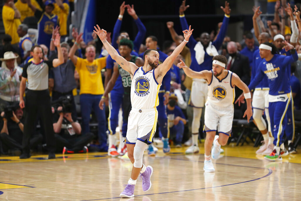 Golden State Warriors guard Stephen Curry (30) celebrates after guard Klay Thompson, right, shot a 3-point basket during the second half of Game 5 of the NBA Finals against the Boston Celtics in San Francisco, Monday, June 13, 2022. (AP Photo/Jed Jacobsohn)