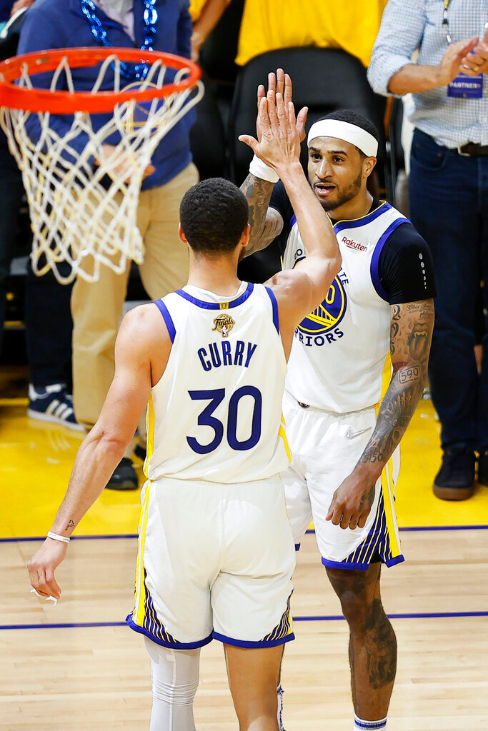 Golden State Warriors guard Stephen Curry (30) celebrates with guard Gary Payton II during the second half of Game 5 of the NBA Finals against the Boston Celtics in San Francisco, Monday, June 13, 2022. (AP Photo/John Hefti)