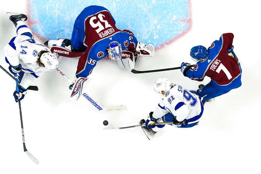 Colorado Avalanche goaltender Darcy Kuemper (35) blocks a shot by Tampa Bay Lightning center Steven Stamkos (91) during the overtime in Game 1 of the NHL Stanley Cup Final on Wednesday, June 15, 2022, in Denver. (AP Photo/John Locher)