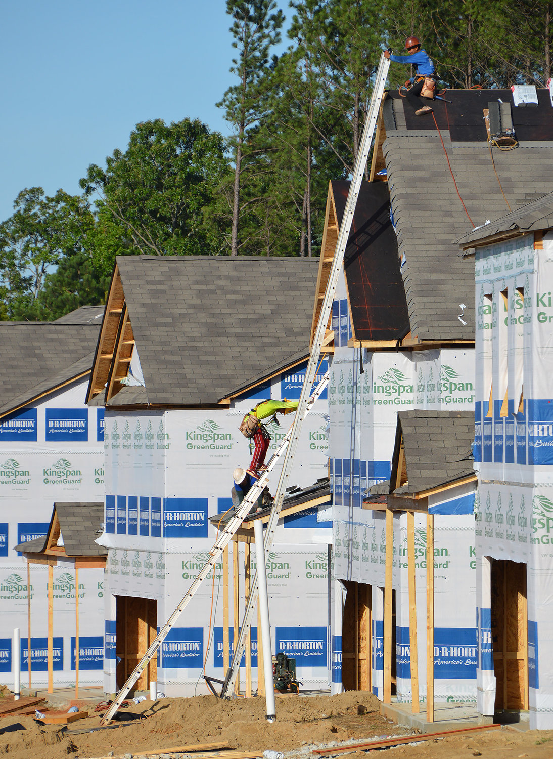 Roofers work on houses under construction in a new subdivision in Dallas, Ga., June 10, 2022. (Index/Henry Durand)