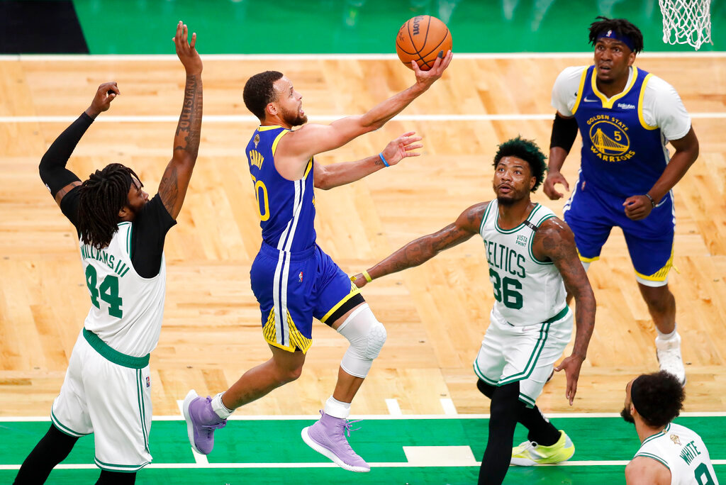 Golden State Warriors guard Stephen Curry (30) goes up for a shot against Boston Celtics guard Marcus Smart (36) and center Robert Williams III (44) during the first quarter of Game 6 of the NBA Finals, Thursday, June 16, 2022, in Boston. (AP Photo/Michael Dwyer)