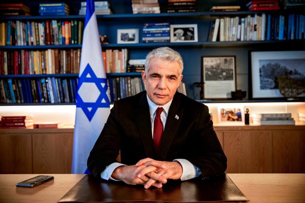 Israeli opposition leader Yair Lapid poses for a photo at his office in Tel Aviv, Israel, May 21, 2020. (AP Photo/Oded Balilty, File)
