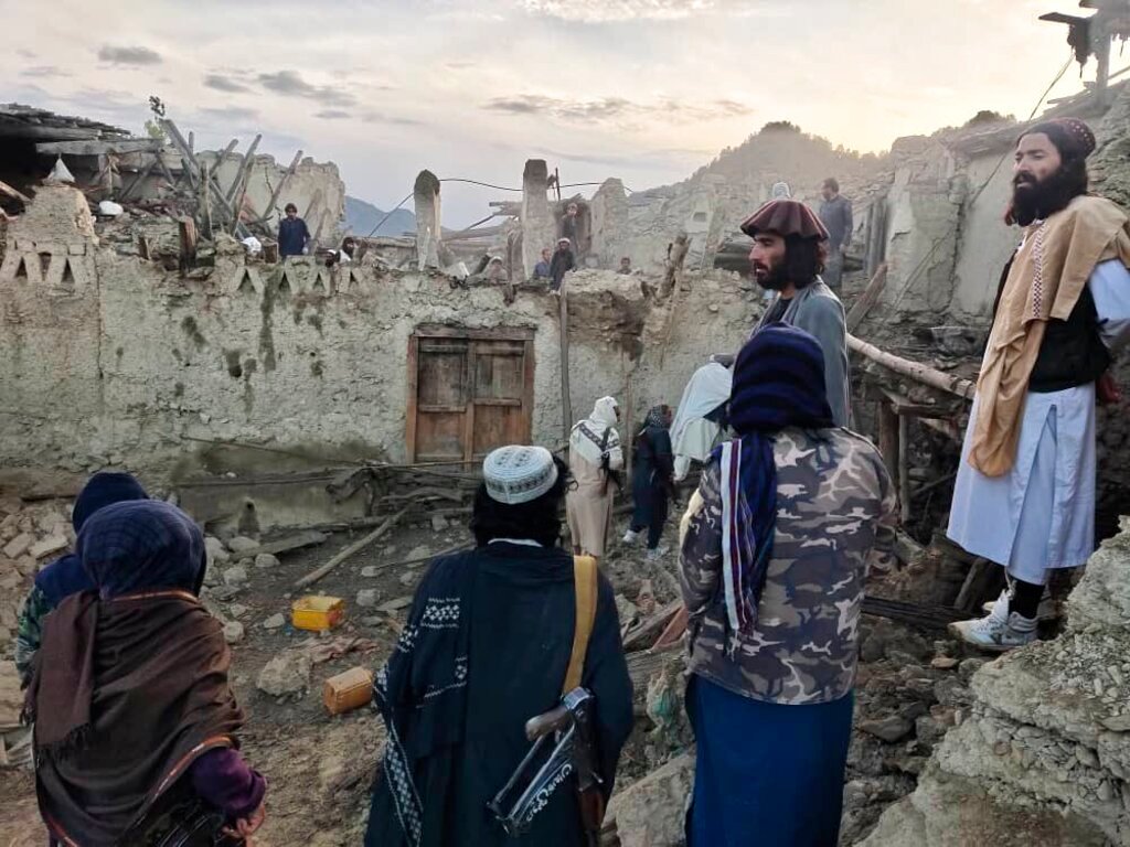 Afghans look at destruction caused by an earthquake in the province of Paktika, eastern Afghanistan, Wednesday, June 22, 2022. (Bakhtar News Agency via AP)