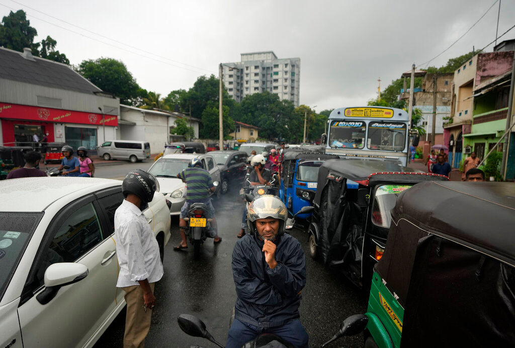 Scooterists and motorists wait in long lines at a fuel station in in Colombo, Sri Lanka, Saturday, June 11, 2022. (AP Photo/Eranga Jayawardena)