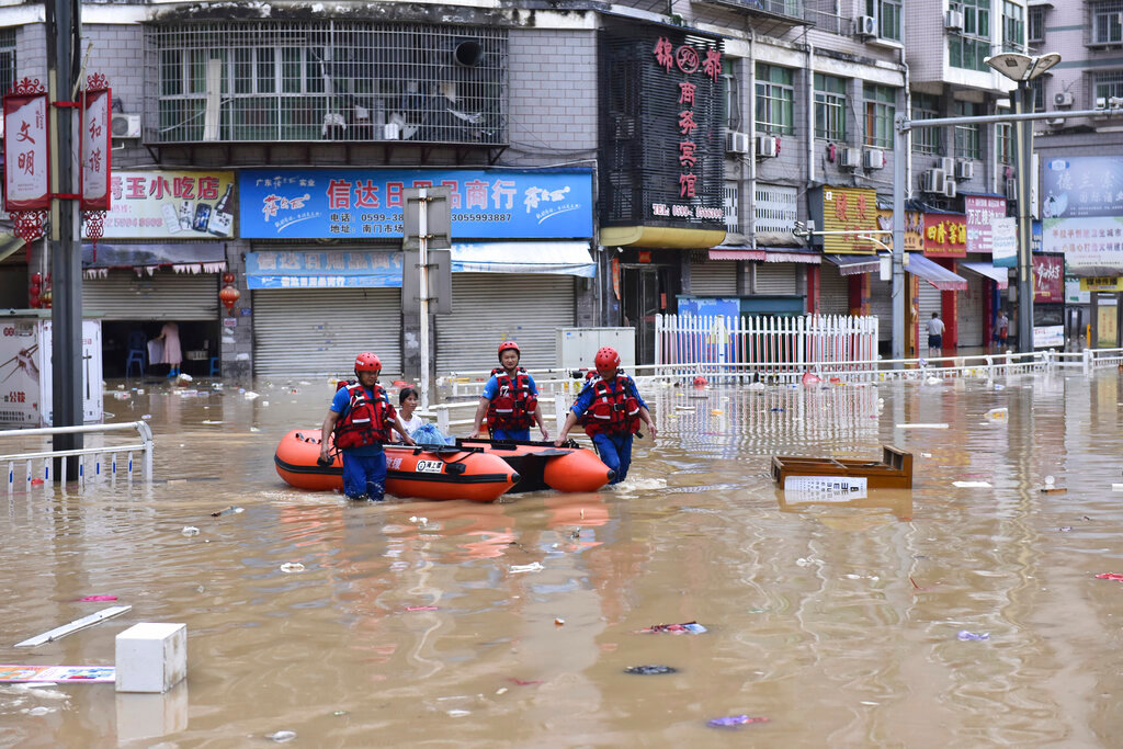 Rescuers evacuate people stranded after flooding caused by heavy rain in the city of Jian'ou in southeast China's Fujian Province, June 19, 2022. (Huang Jiemin/Xinhua via AP)